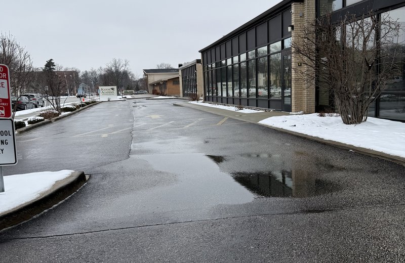 Commercial snow removal in Chicago — parking lot plowed to bare asphalt with snow cleared to the edges