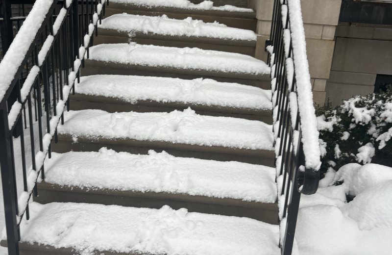 Residential snow removal in Chicago — snow-covered home front steps we clear and salt